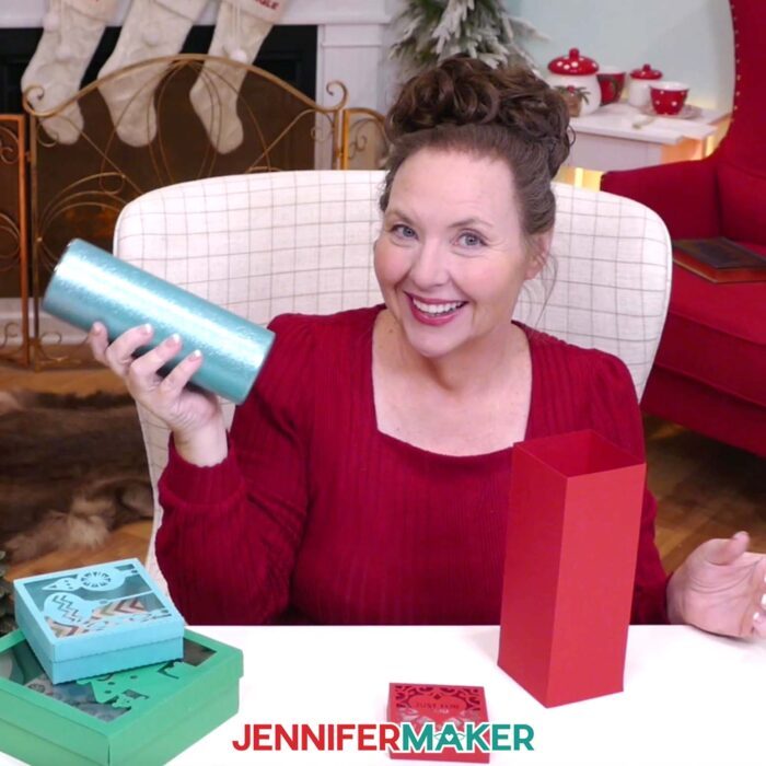 Jennifer Maker is getting ready to place a sparkling blue tumbler into a red DIY gift box.