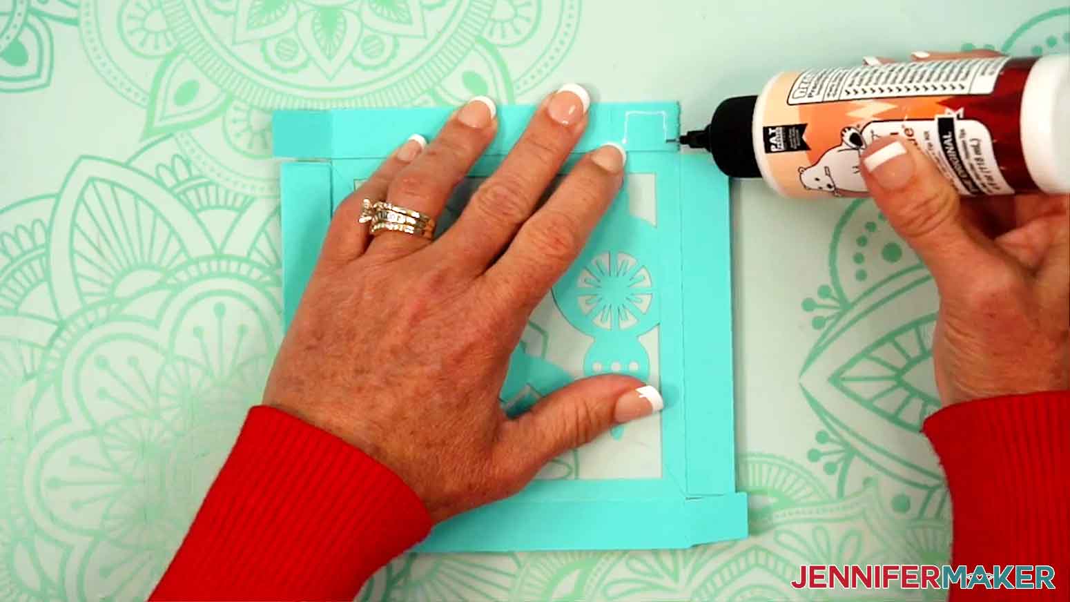 The corner is being attached to the small tab to the matching side piece, aligning the side&rsquo;s edge along the tab&rsquo;s crease.