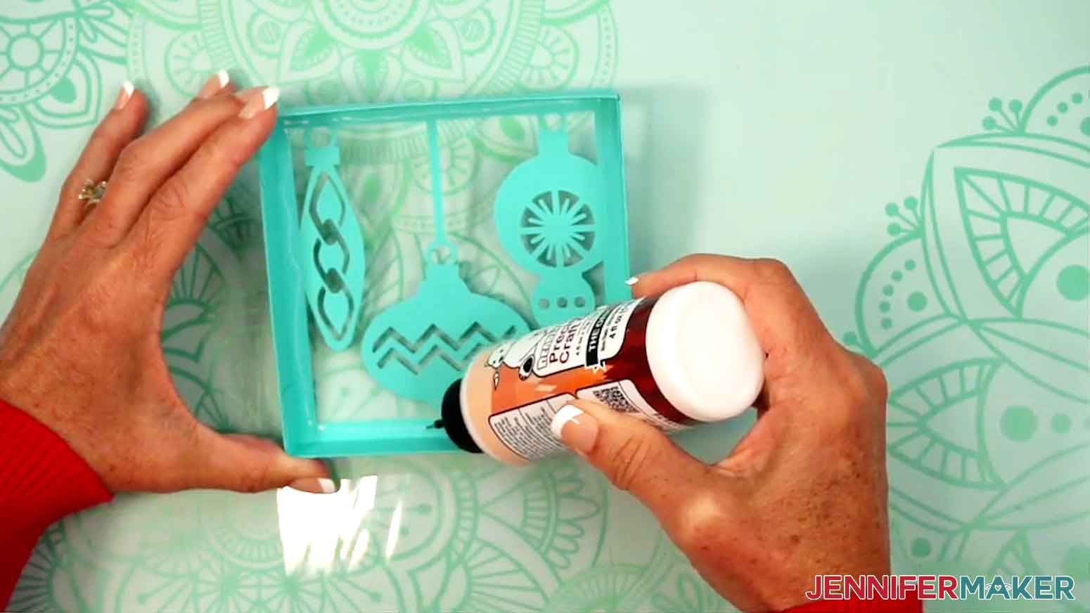 Glue is being applied to the inner edges of the lid of the gift box.