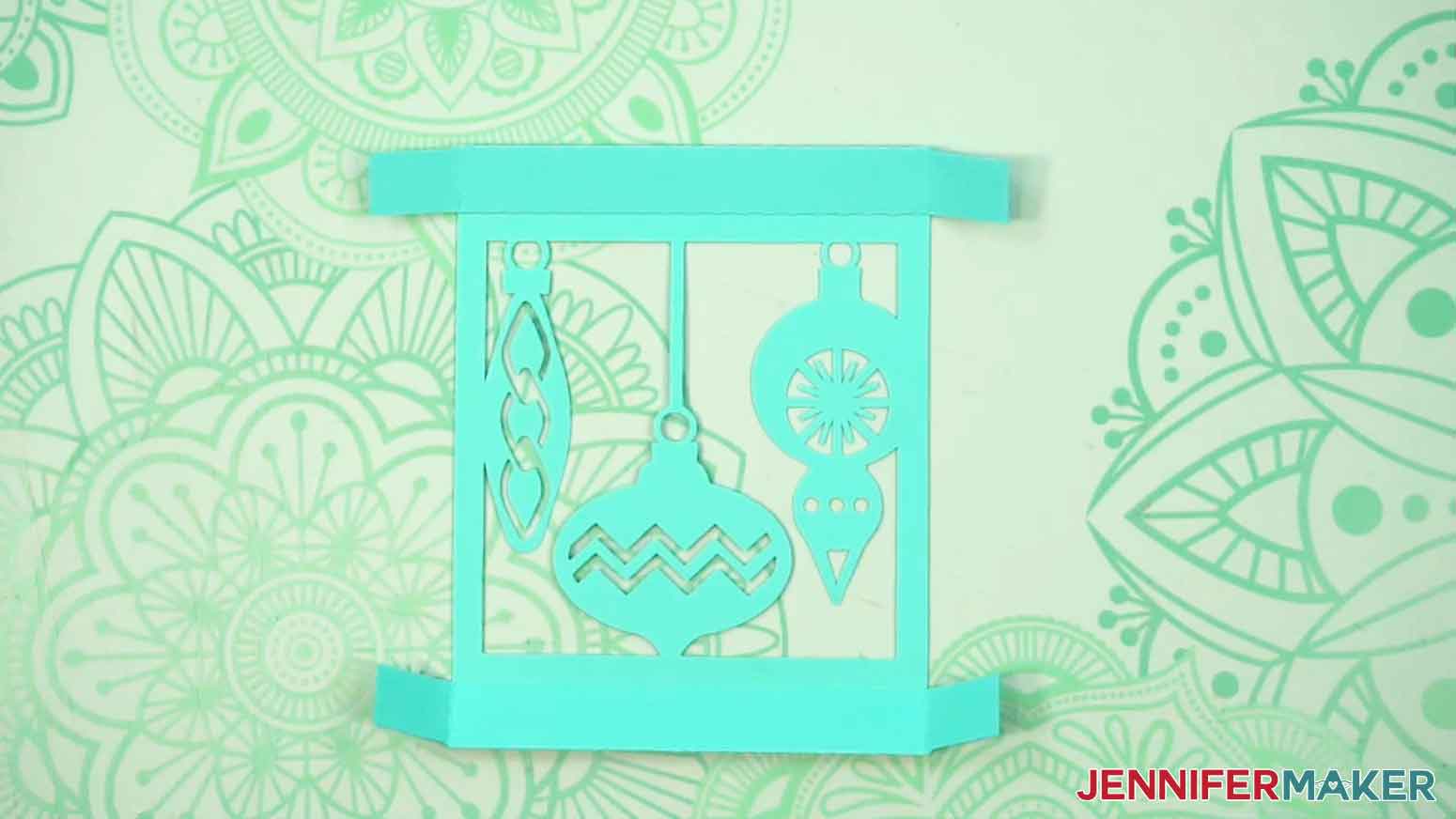 The lid for gift box is shown face down on the table with the sides folded down and glued.
