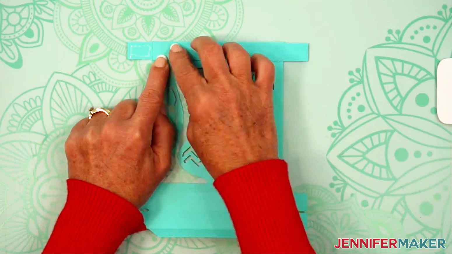 Glue has been applied in a square shape on the corner tab of the gift box.