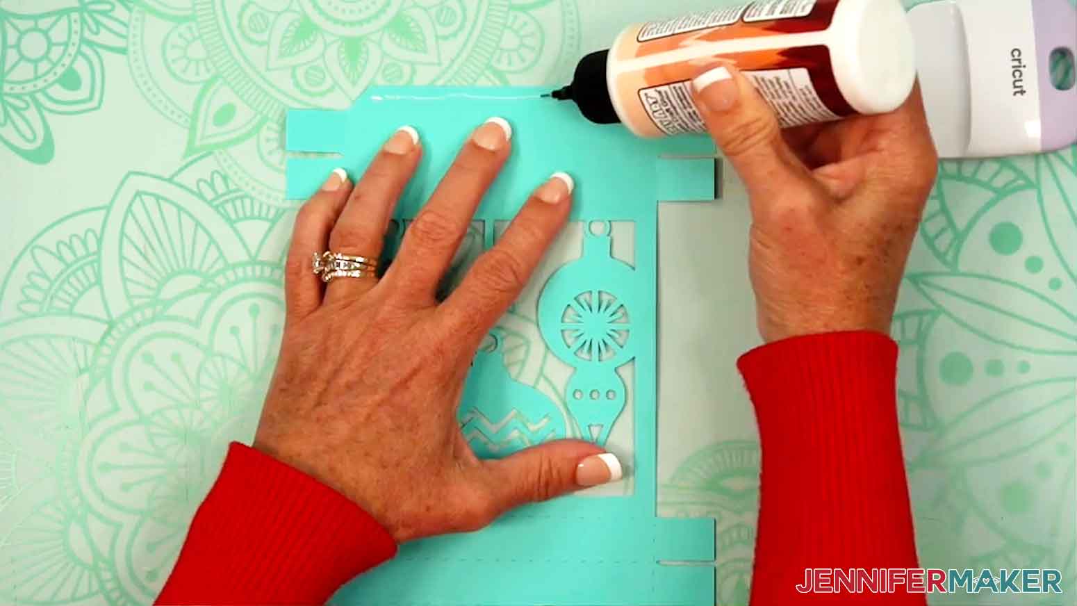 Glue is being applied to the inside of the top folding pieces to make the lid of the gift box.