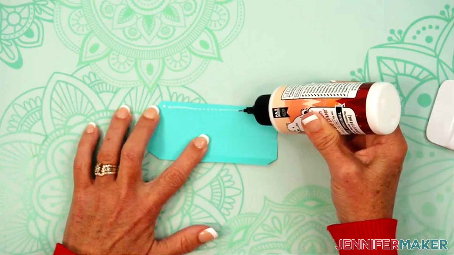 Glue is applied to side piece of the gift box lid.