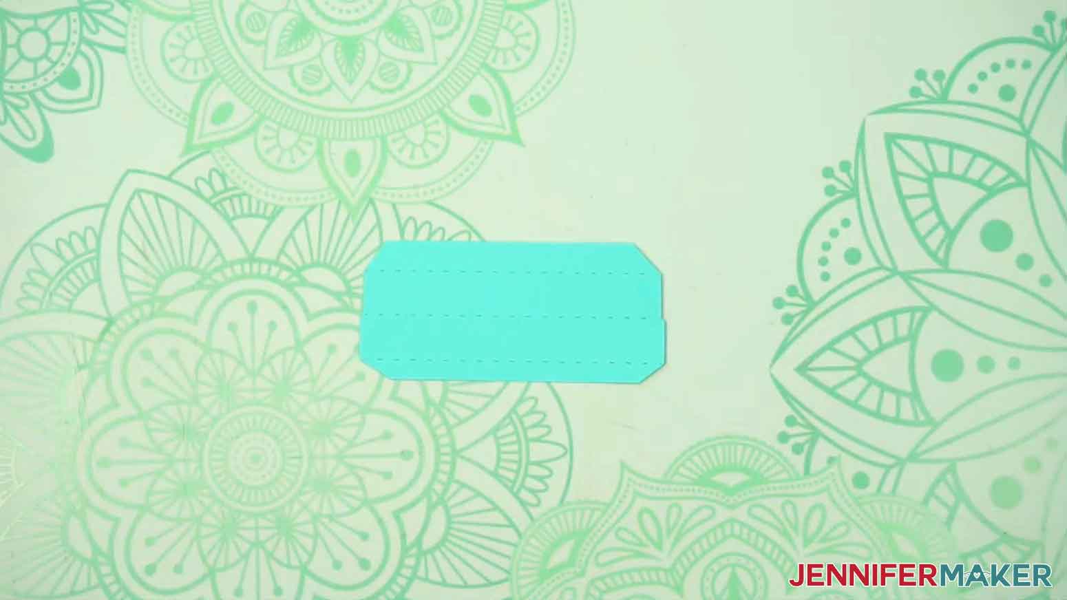 The side of the lid of the gift box is shown face up on the desk.