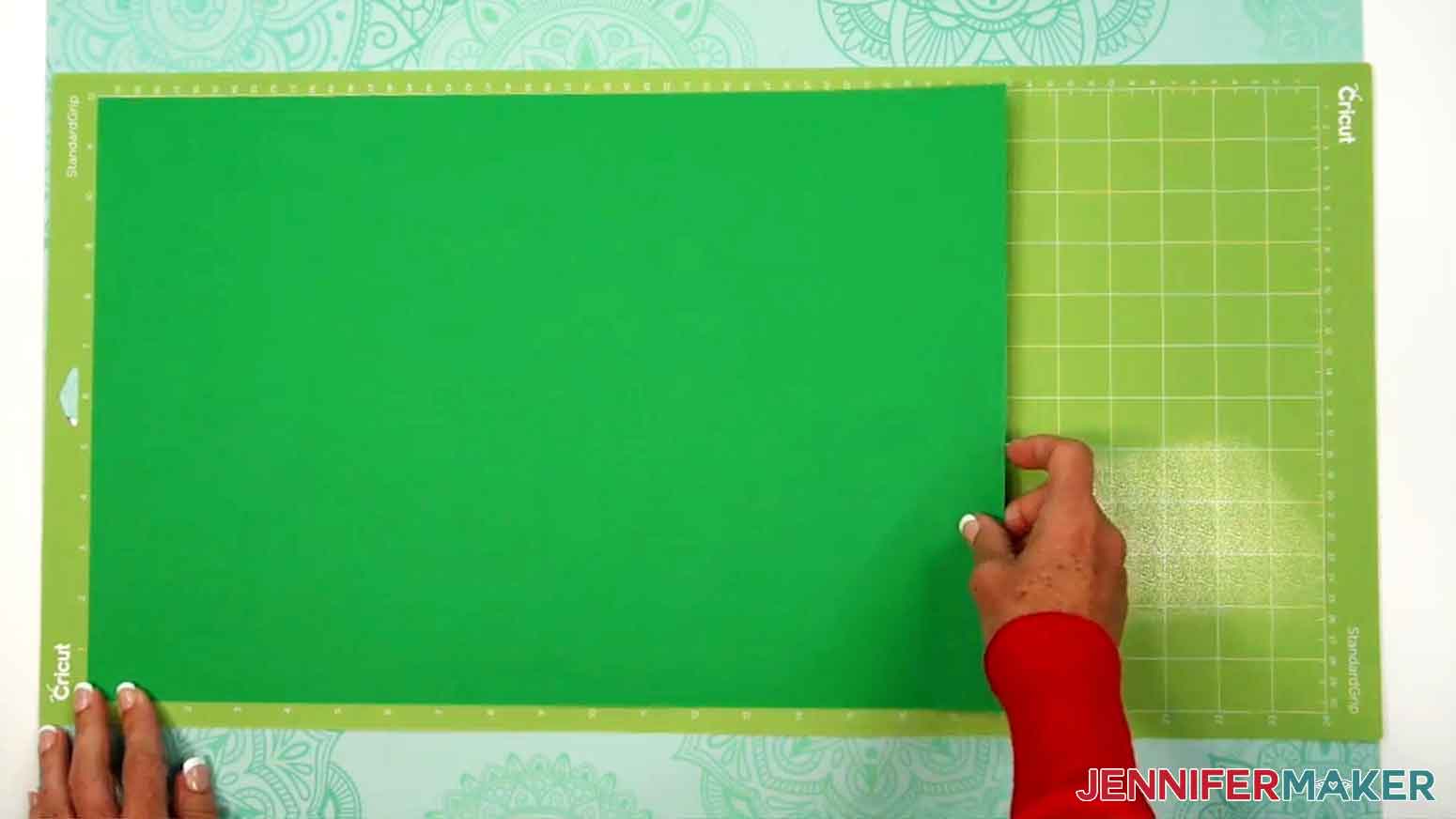 The cardstock is being applied to the 12 x 24 Cricut standard grip green mat.