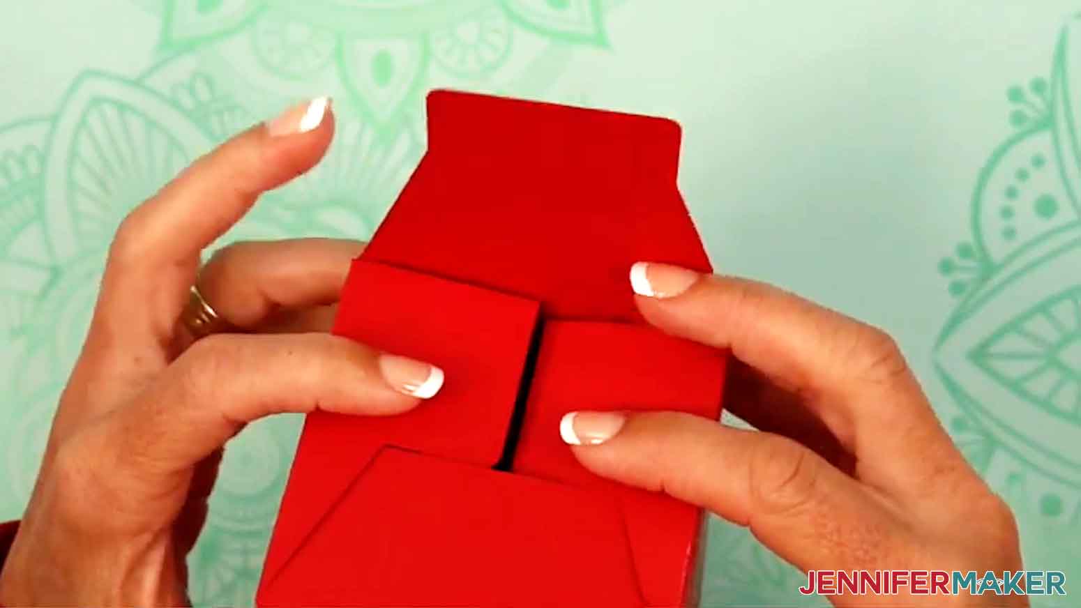 The tumbler gift box is turned upside down and the bottom sides are folded in.