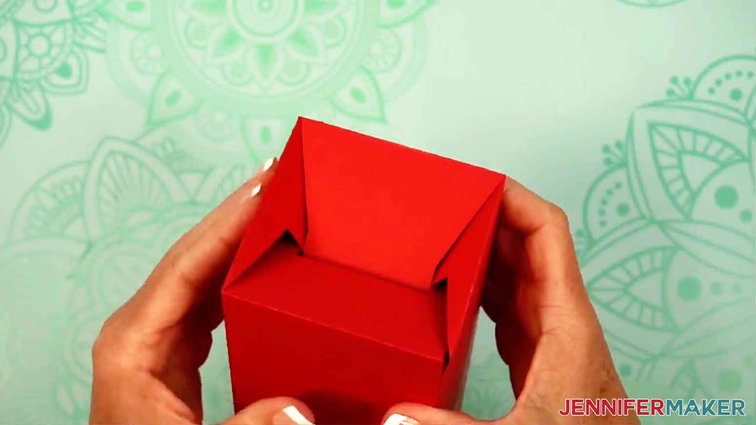 The tumbler box is turned upside down and the last tab is folded into the slot to make a finished bottom to the box.