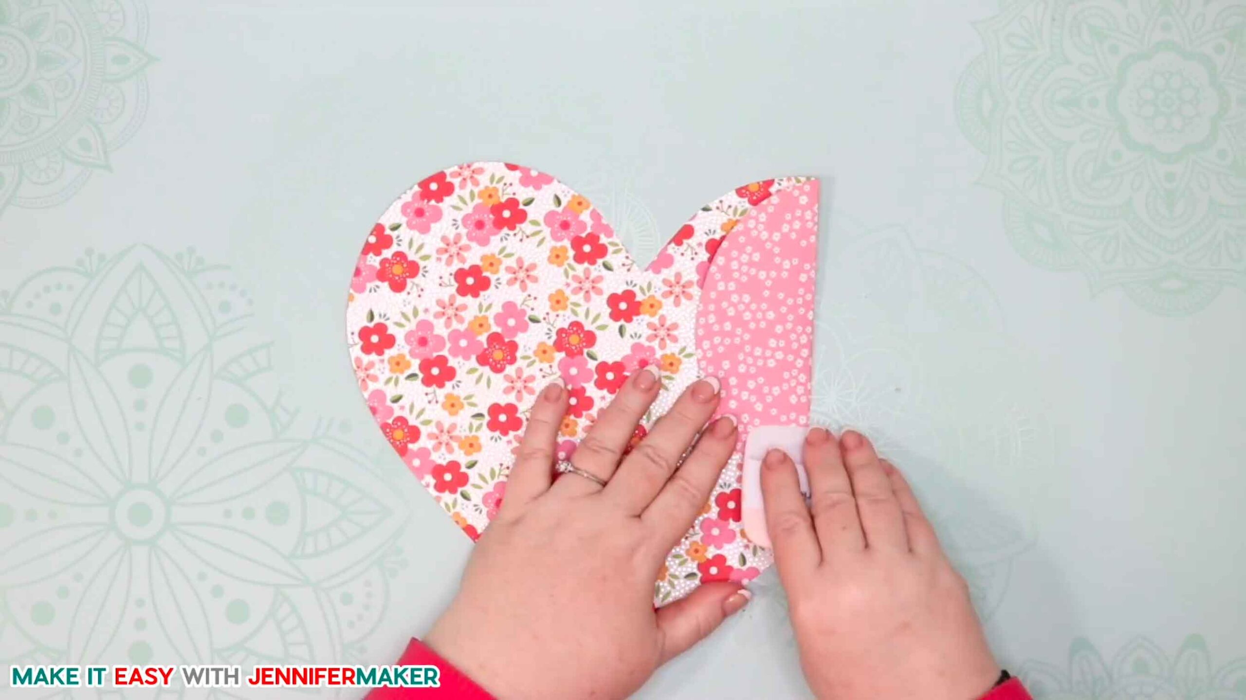 Scraping the crease of the easy paper heart envelope card for a crisper fold