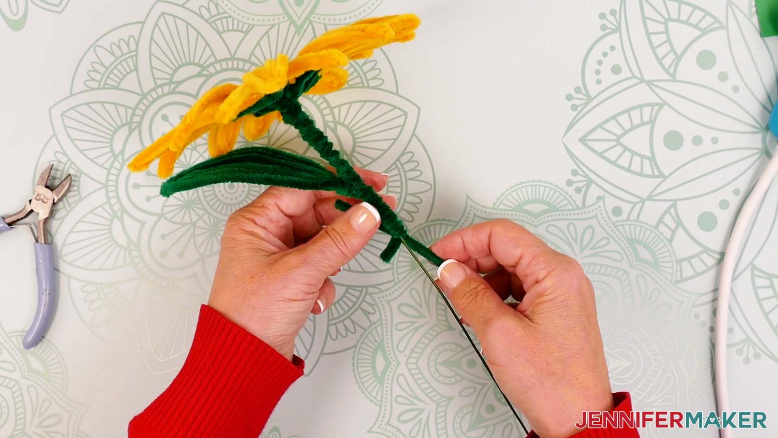 With a few inches of the wrapping pipe cleaner left, add a new one by overlapping their ends by about 0.5 inch.