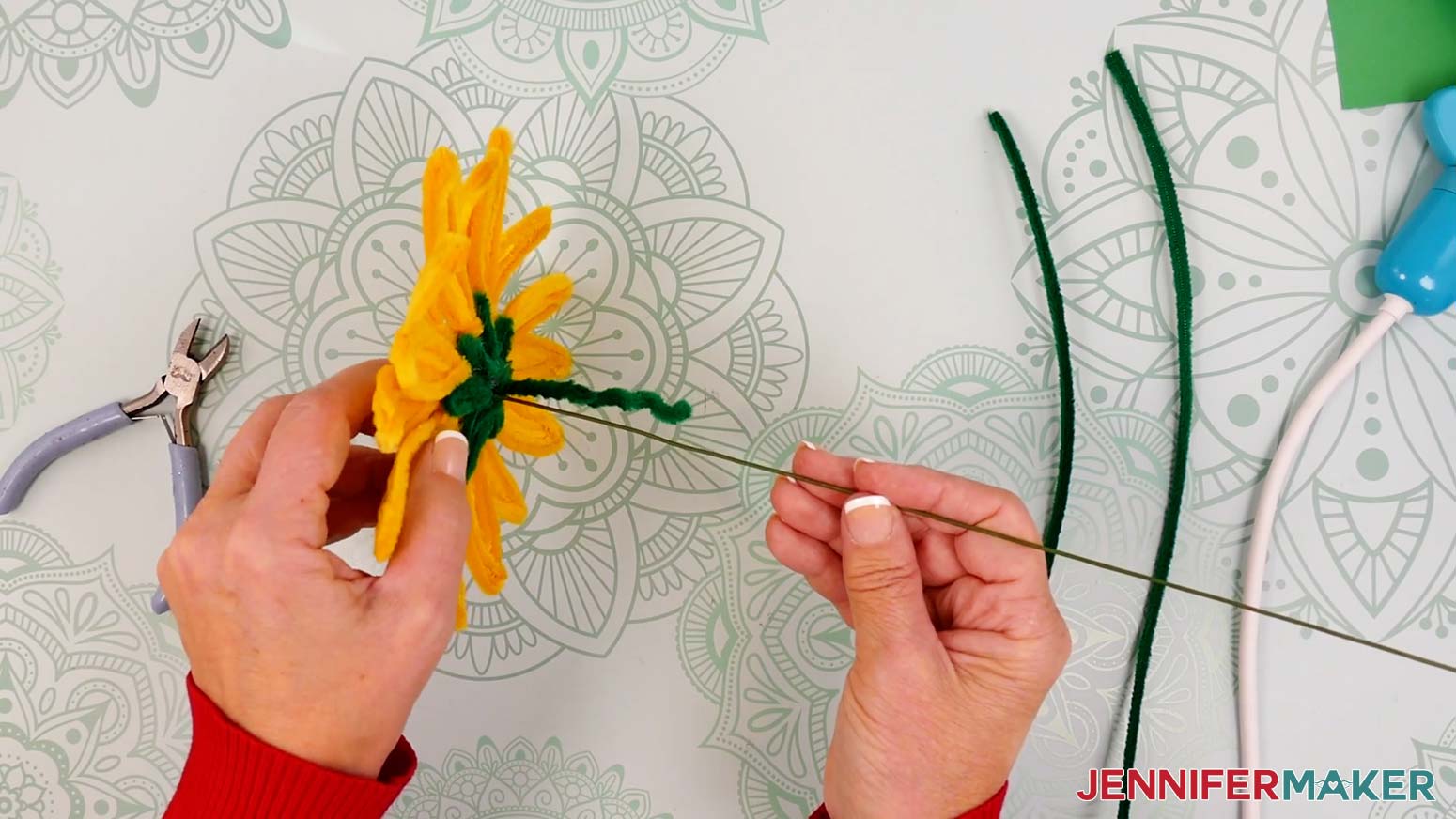Press one end of the floral wire into the bottom of the flower right next to the twisted pipe cleaners.