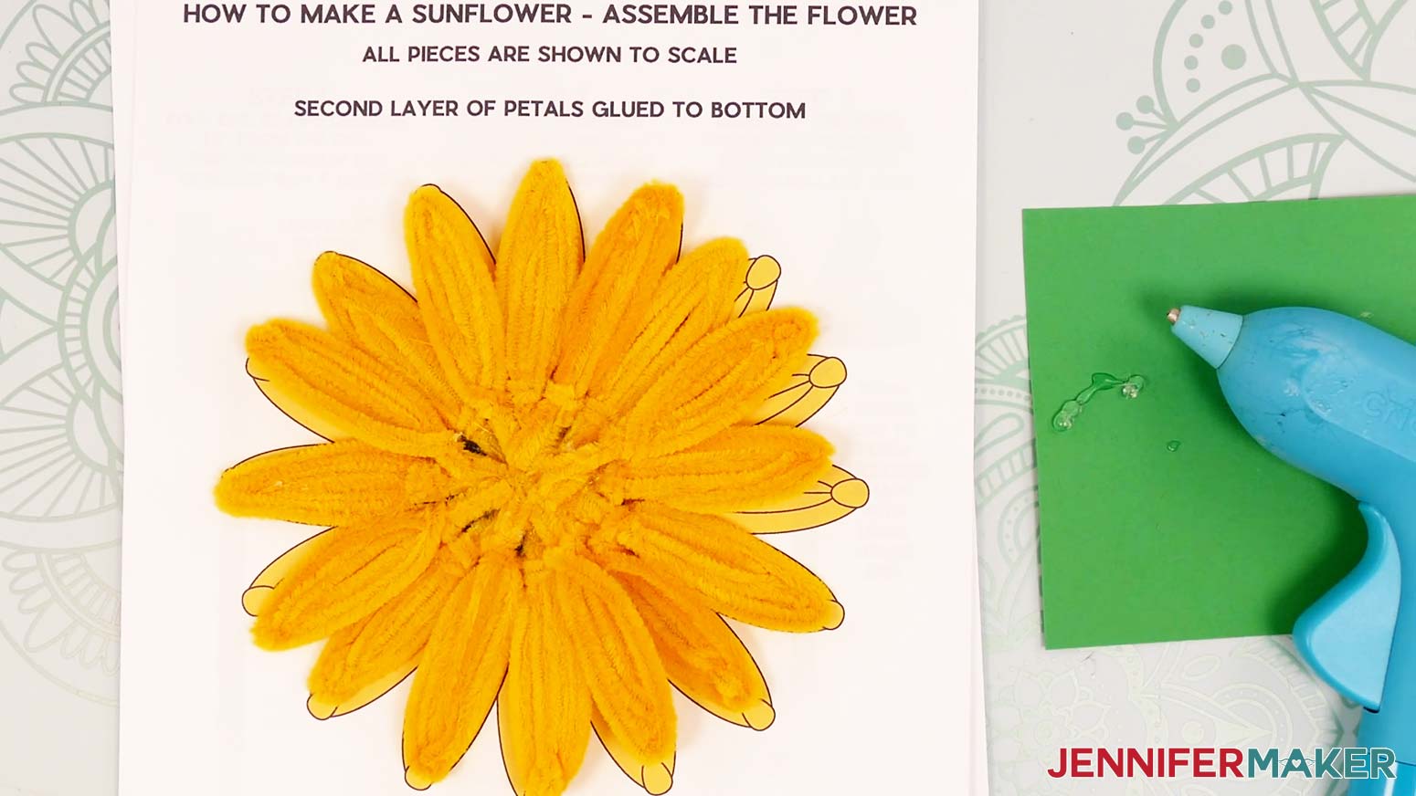 All 16 pipe cleaner sunflower petals glued onto the brown center, with the second set of eight filling in the open sections.