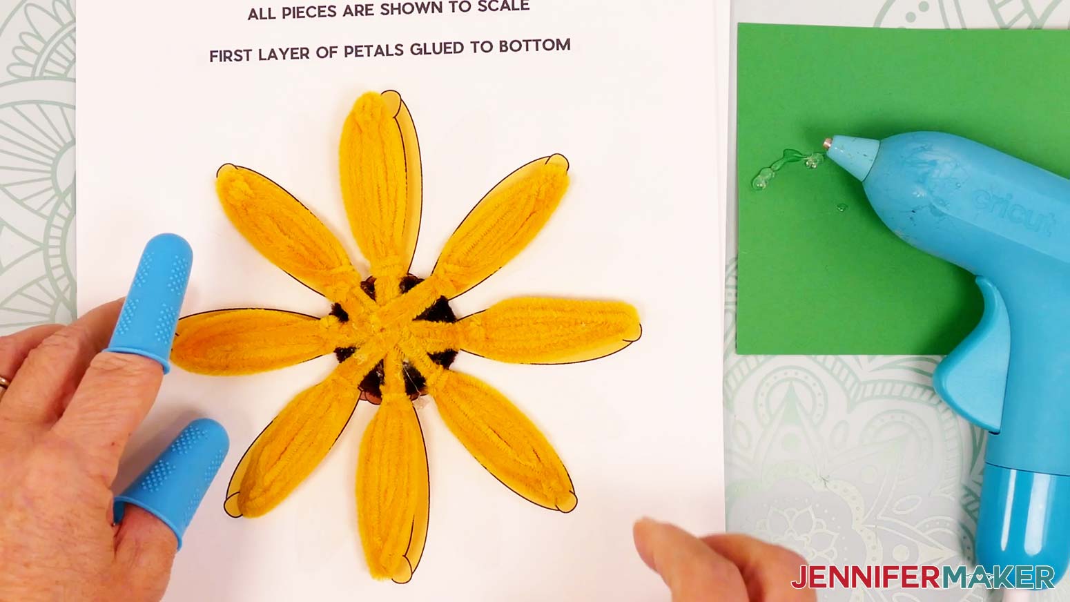 The first eight pipe cleaner sunflower petals glued onto the brown center.