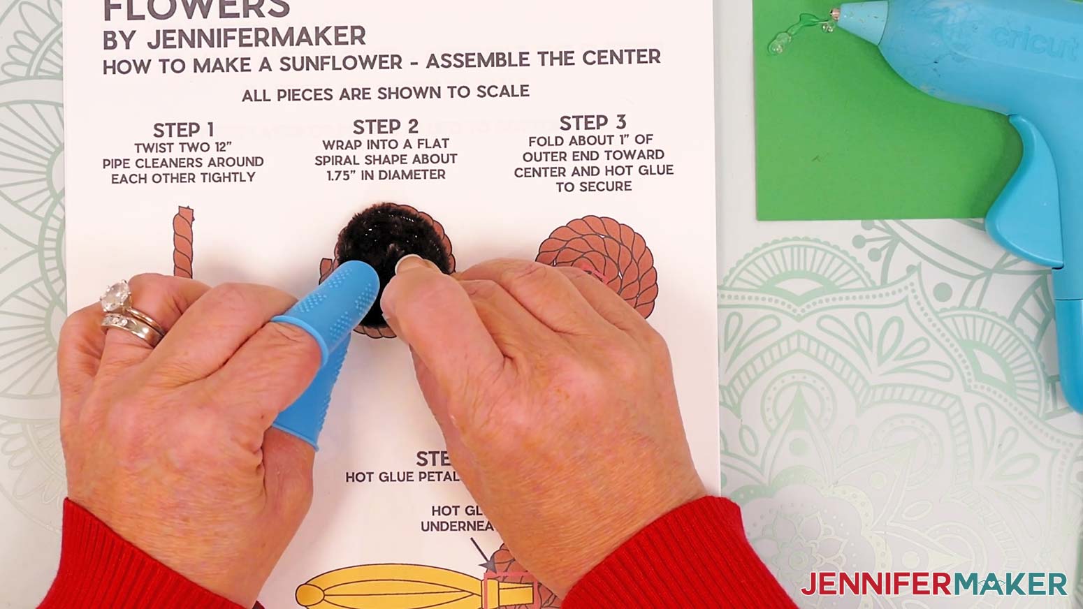 Keeping the brown spiral secure, fold the outer pipe cleaner’s end in toward the middle.