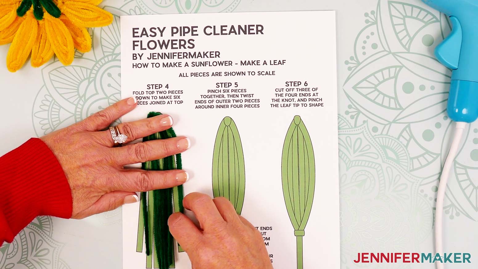 Hold the bottom double pipe cleaner leaf sections still, and fold the upper legs down on either side.