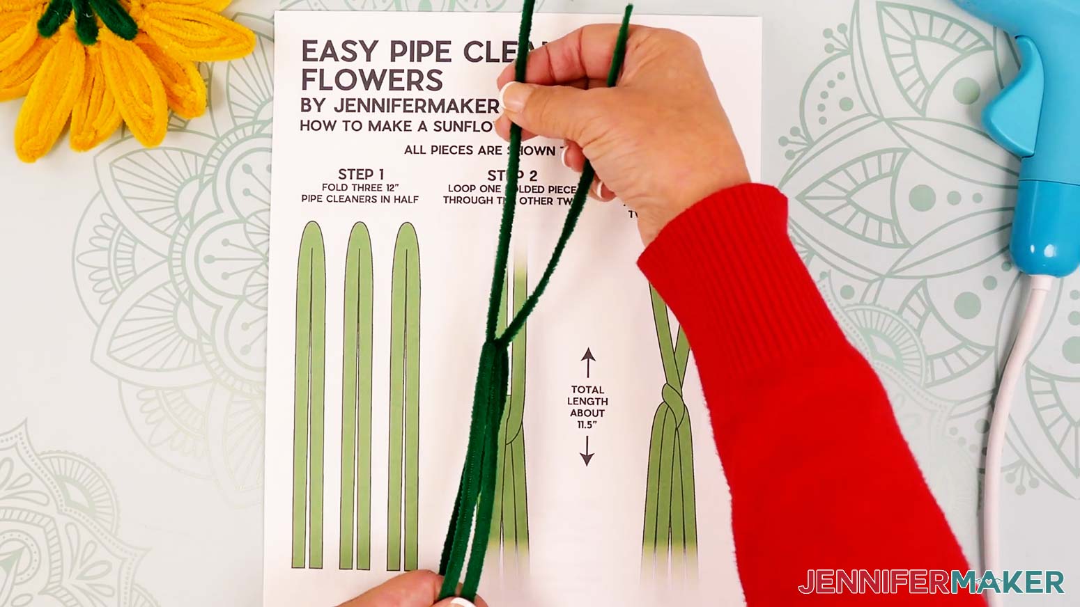 Insert the leg of one pipe cleaner leaf piece into the bend of the other two so they are linked.