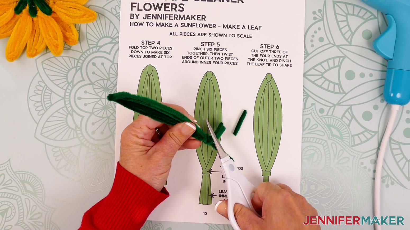 Use scissors to trim three of the four pipe cleaner lengths right below the wraps at the bottom of the leaf.