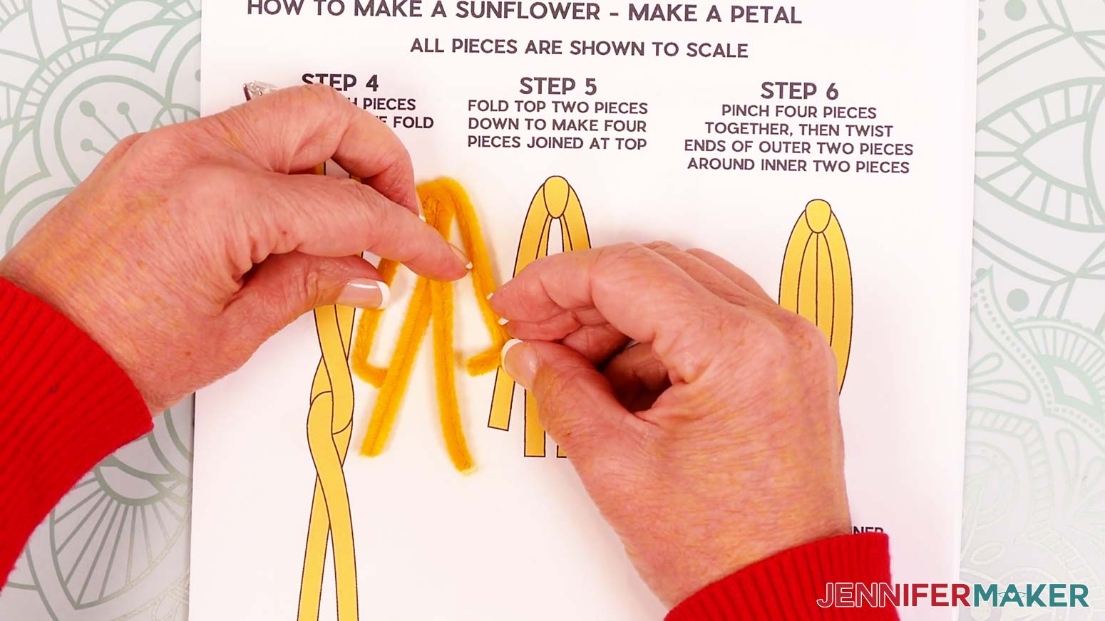 Fold the outer pipe cleaner legs at 90° angles so they cross the middle legs about 0.5 inch from their ends.