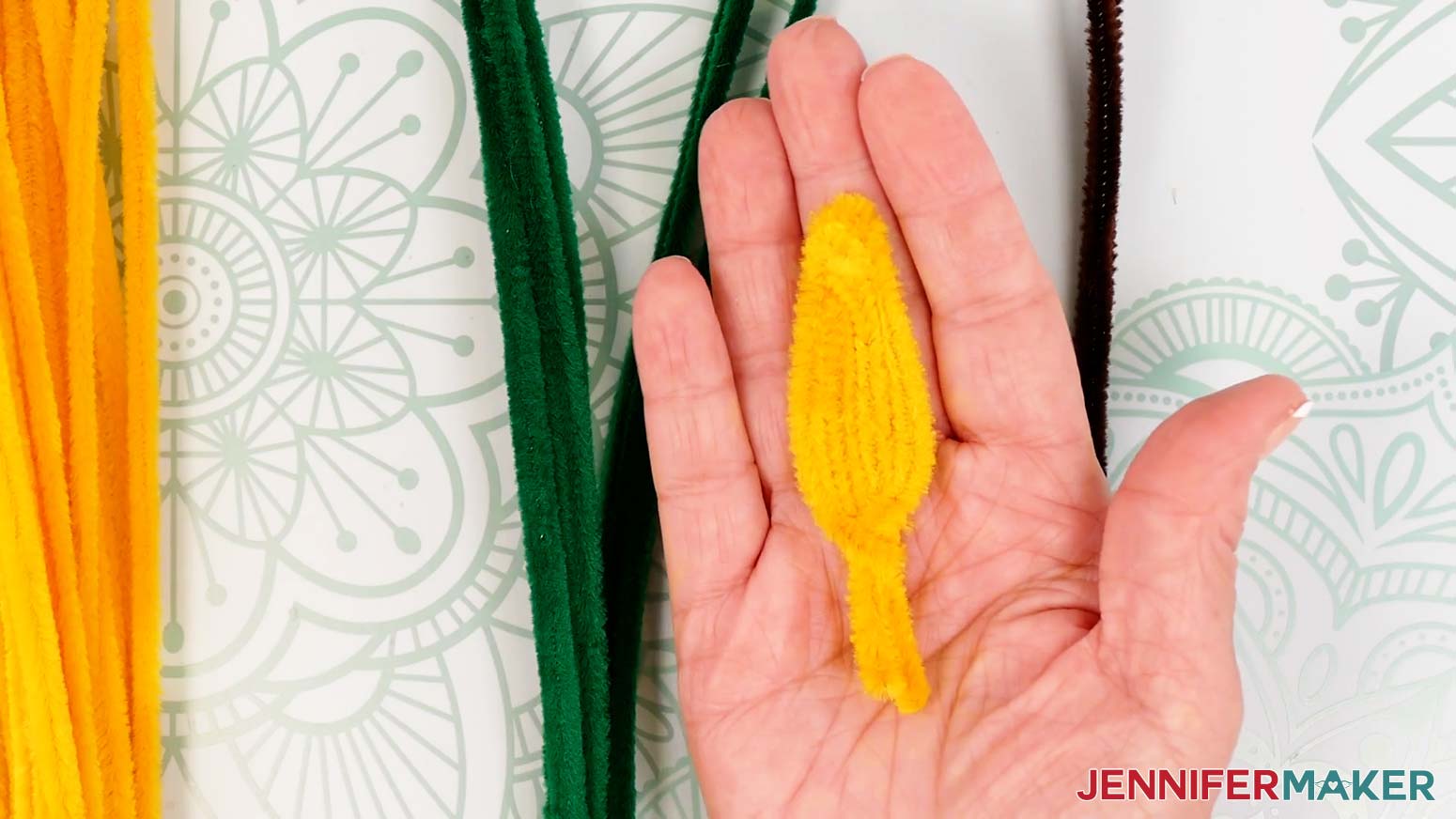 A pipe cleaner sunflower petal with the edges and tip shaped.