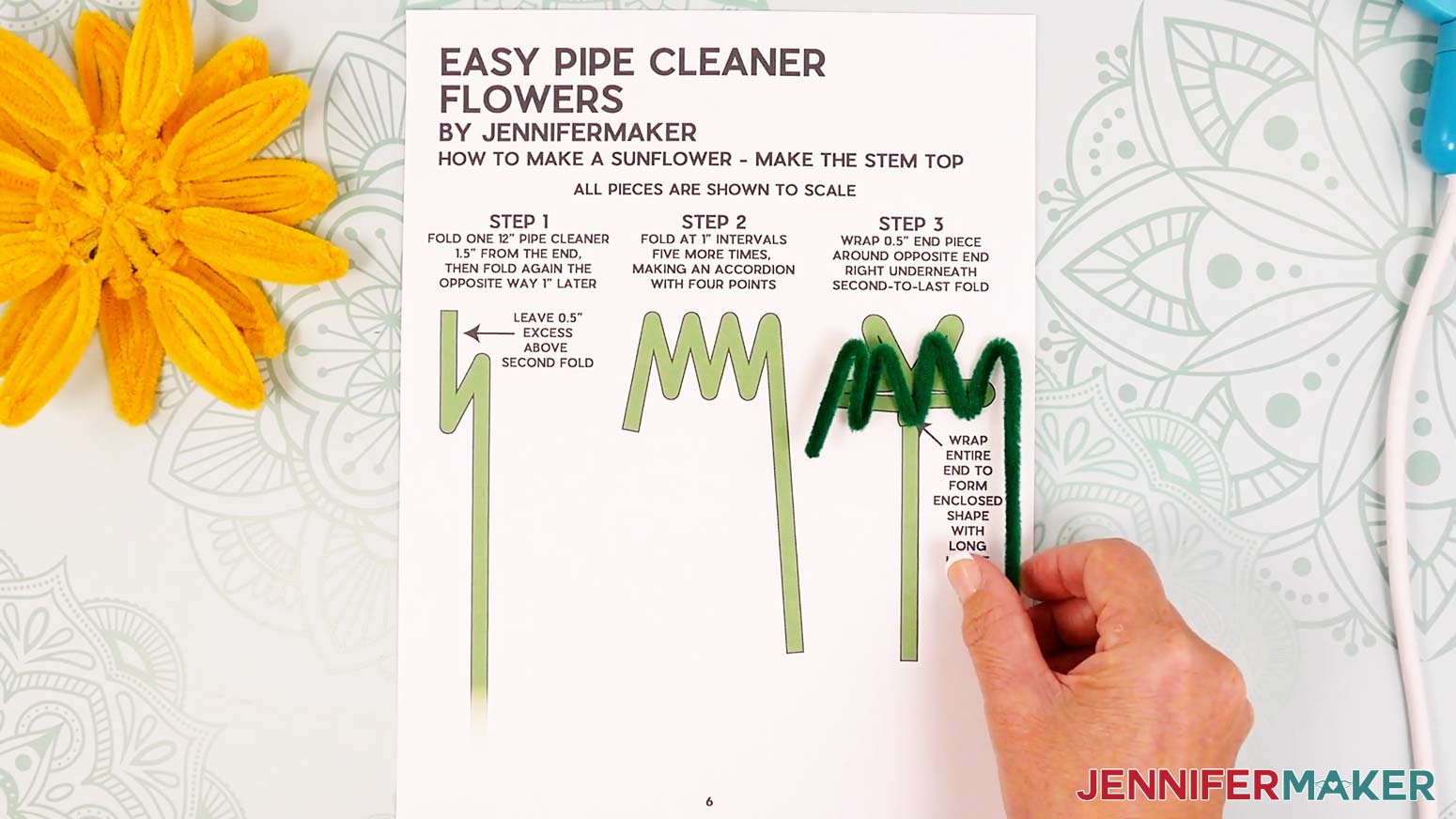 Continue the 1 inch accordion folds on the green pipe cleaner to make four leaves with their points going up.