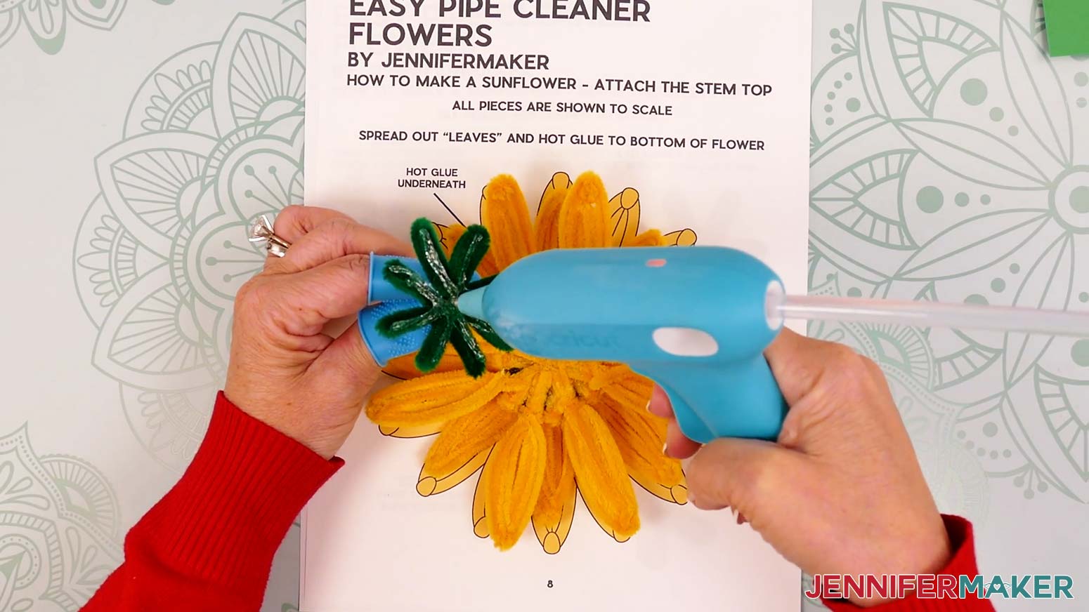 Hold the pipe cleaner stem face up by the twisted end and add hot glue to the tops of the leaves.