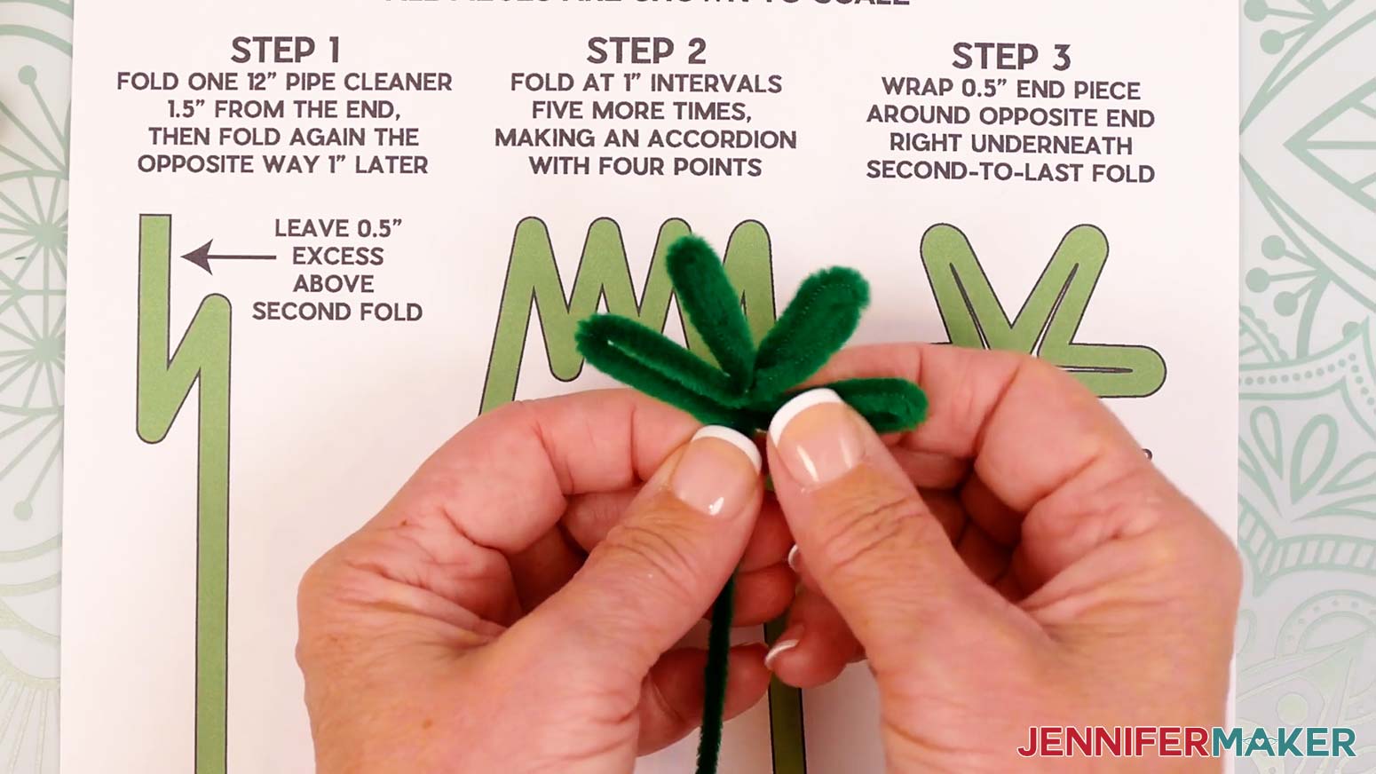 Gently fan out the four pipe cleaner leaves evenly to look like the reference image on the printed guide.