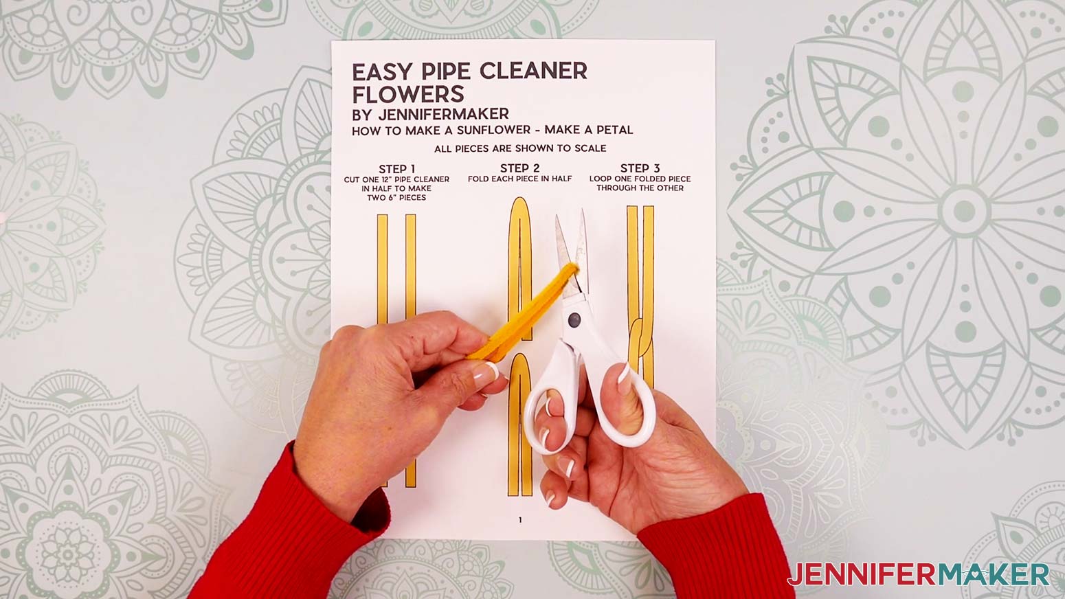 Fold a 12” yellow pipe cleaner in half and use scissors to cut the pipe cleaner at the center.