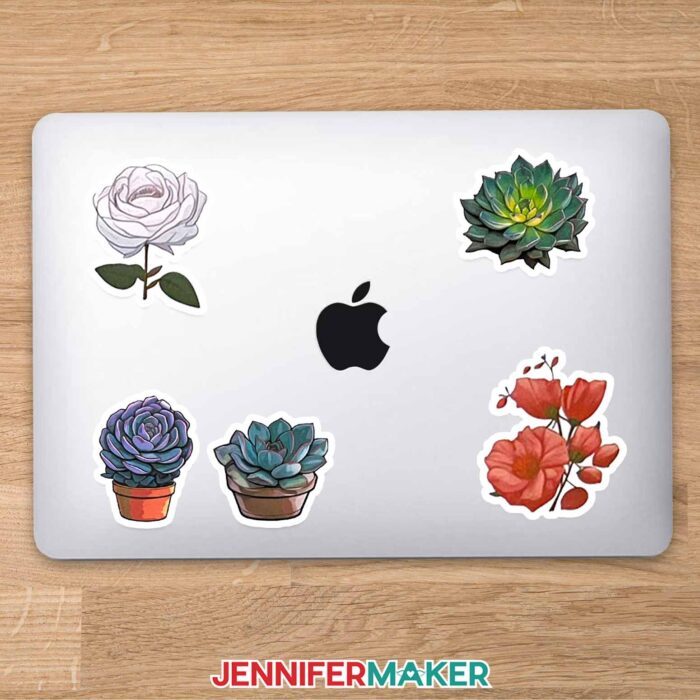 Macbook cover decorated with floral and succulent stickers.
