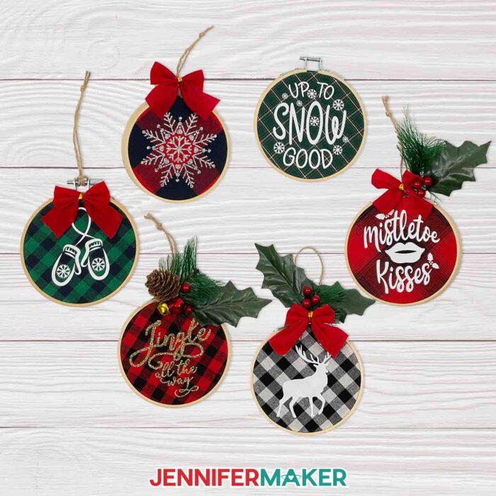 Completed embroidery hoop ornament on woodgrain background. Make Cricut Christmas Ornaments with JenniferMaker's tutorial!