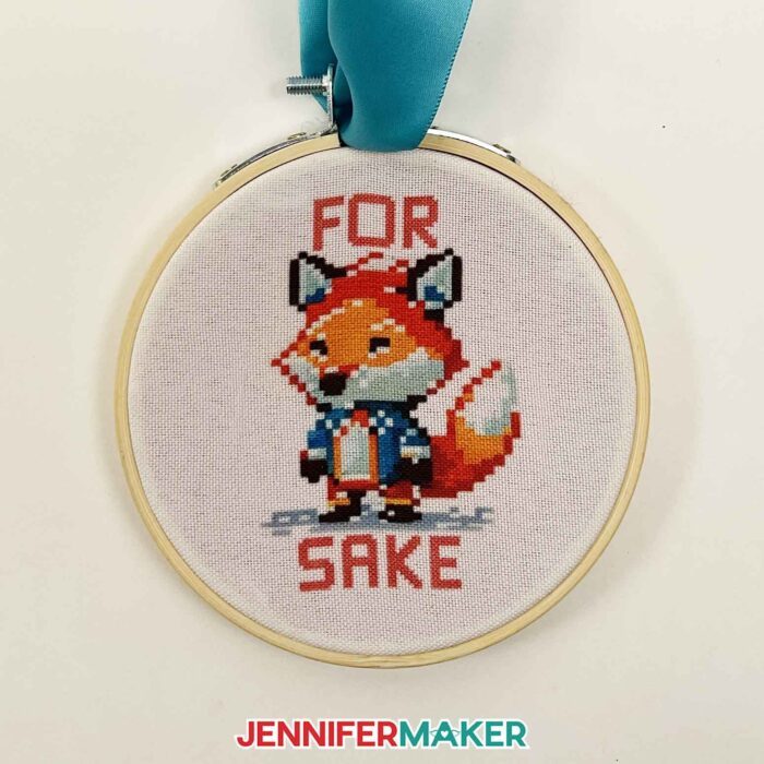 Sublimated fox embroidery hoop ornament. Reads "For Fox Sake." Make Cricut Christmas Ornaments with JenniferMaker's tutorial!
