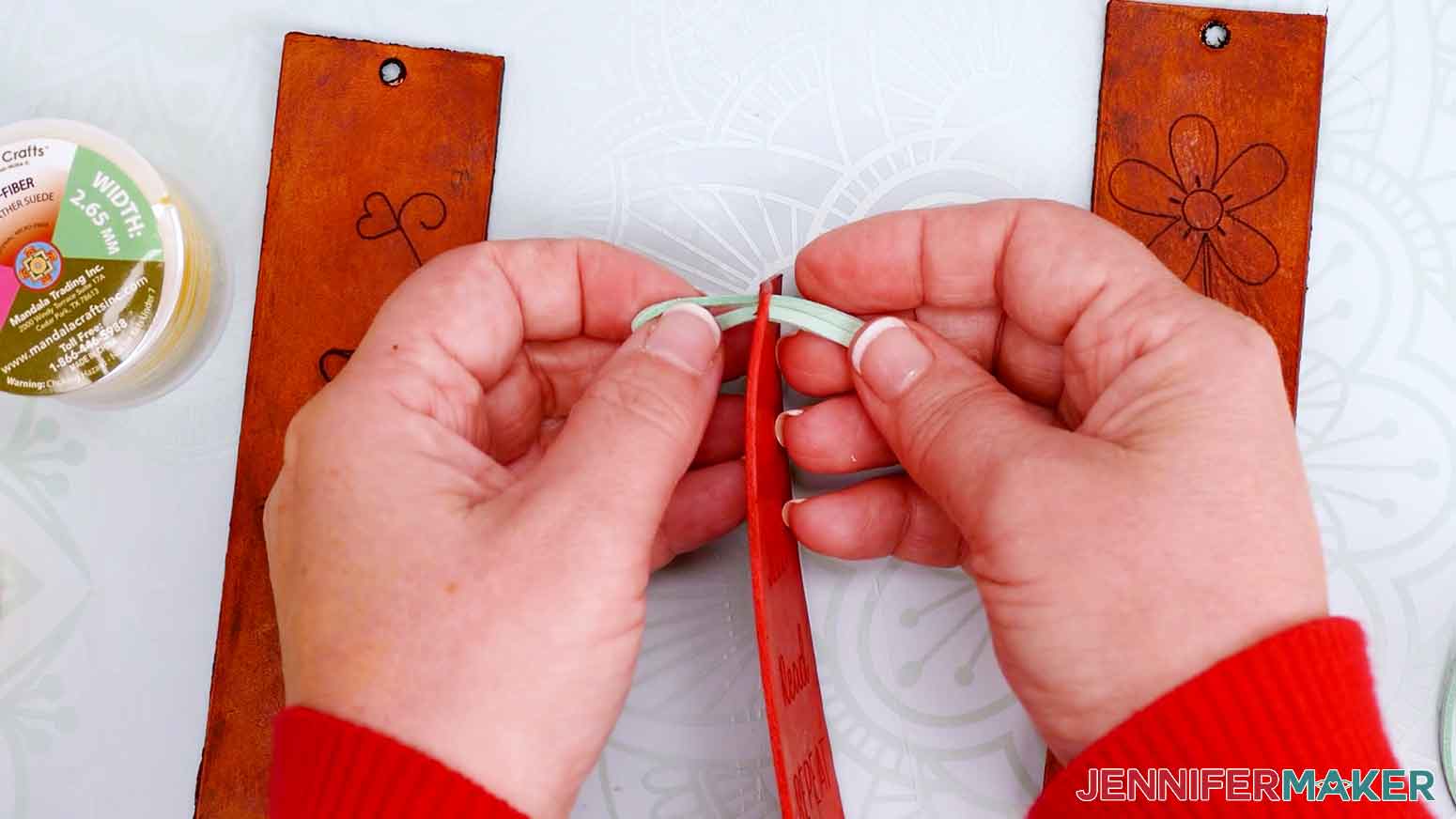Add colored suede string to the leather bookmarks.