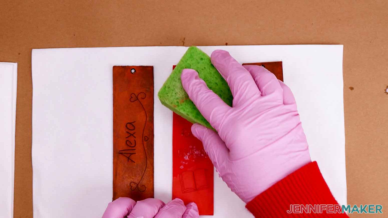 Use a kitchen sponge to apply leather finish to engraved bookmark.