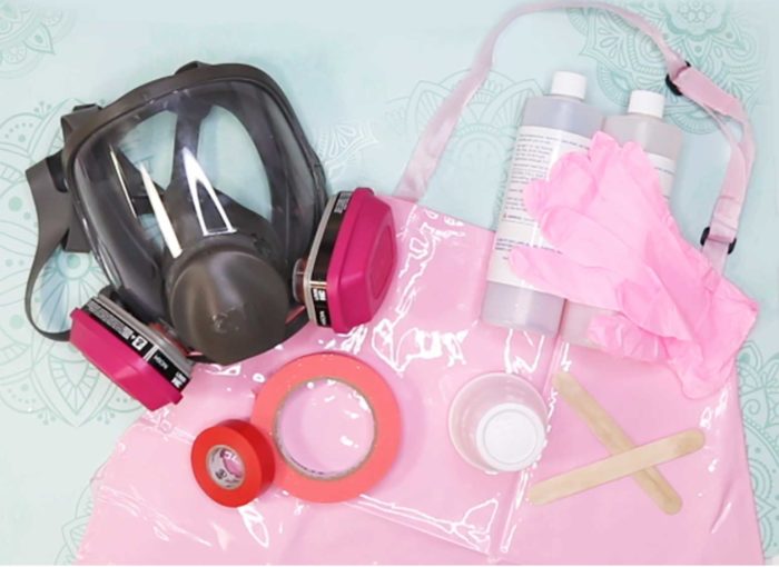 The personal protective equipment JenniferMaker uses when working with epoxy resin for her custom tumblers: respirator, nitrile gloves, PVC apron, tape, disposable cups, and more