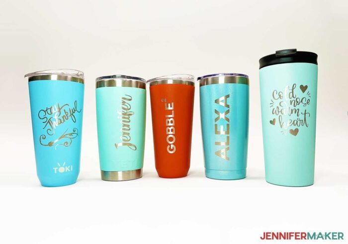 Colorful drink tumblers on a white backgroud with designs removed from the coating using the etch tumblers with Citristrip tutotial.