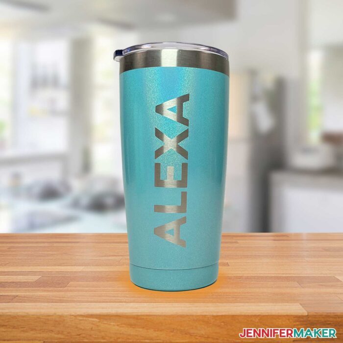 Blue metal cup with Alexa etched vertically in the powder coating using Citristrip.