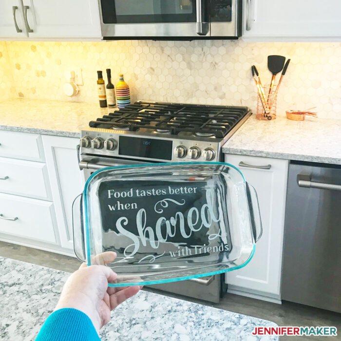 An etched casserole dish in a pretty white kitchen