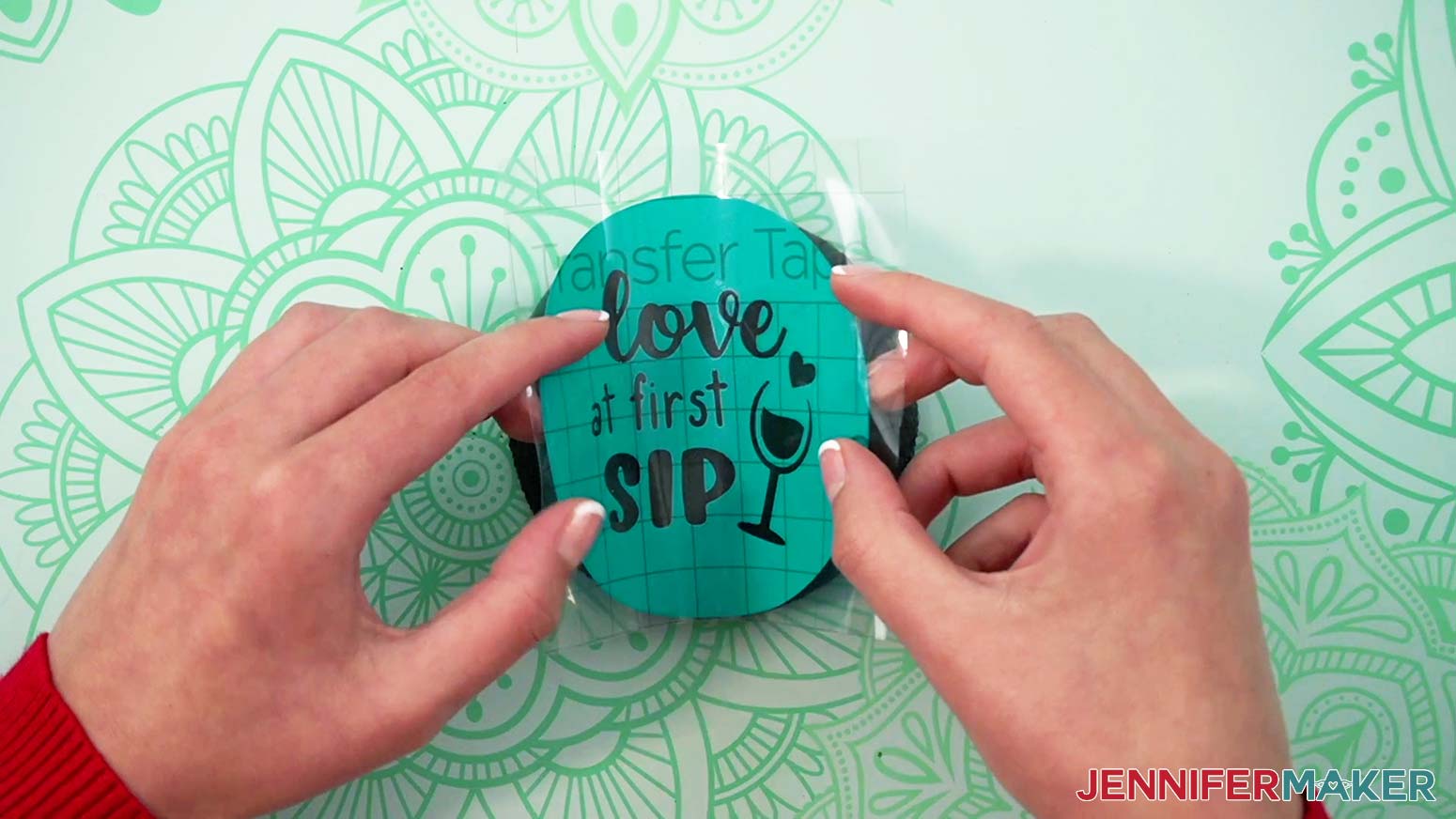 Align the vinyl stencil to the edges of the round slate coaster before pressing it down.