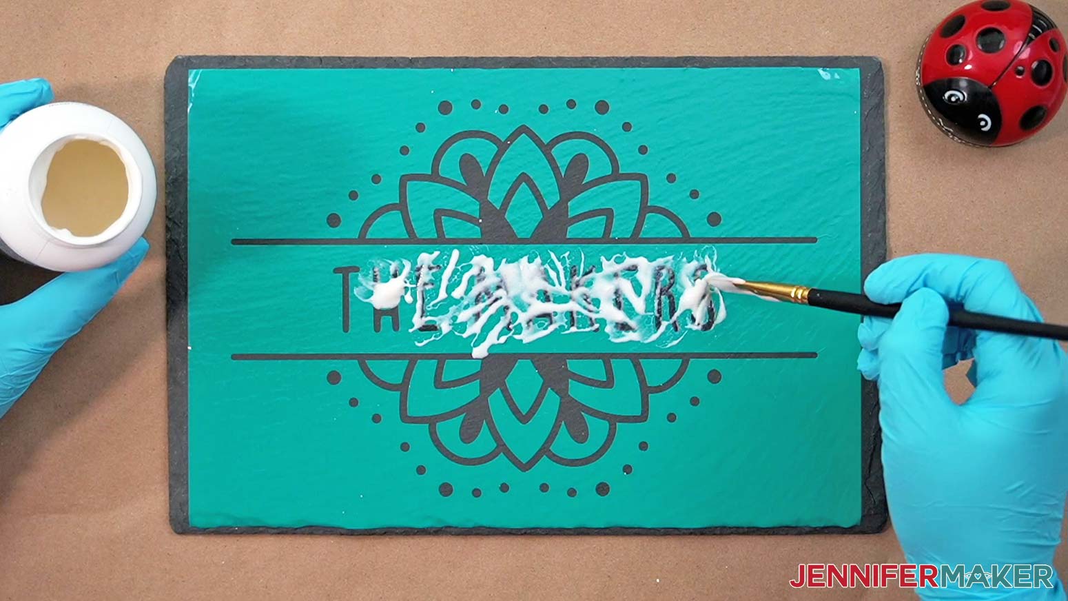 Apply etching cream evenly onto the exposed slate areas of the cheeseboard vinyl design using a bristle brush.