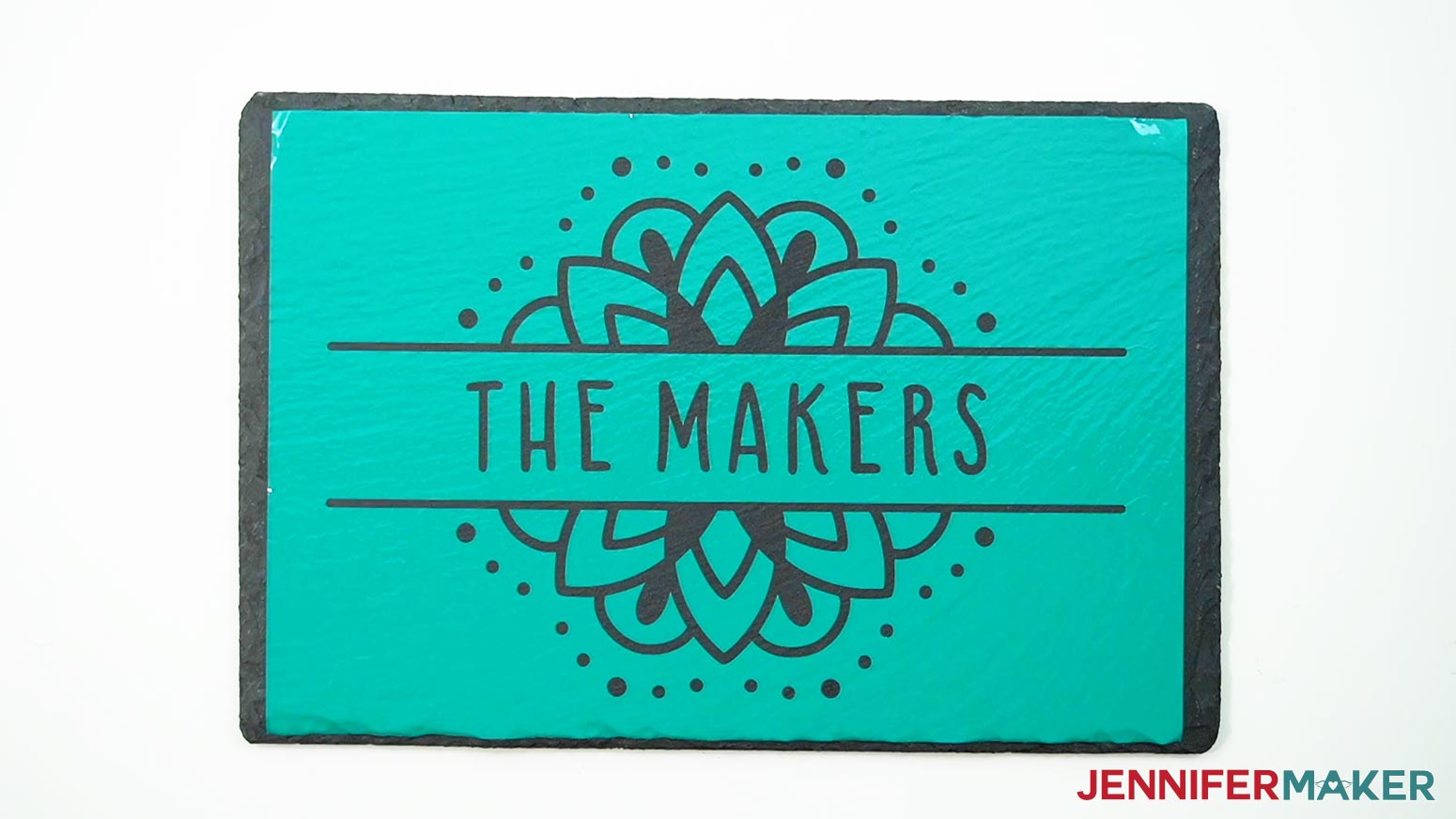 A teal "The Makers" permanent vinyl design properly adhered to a large slate cheeseboard.