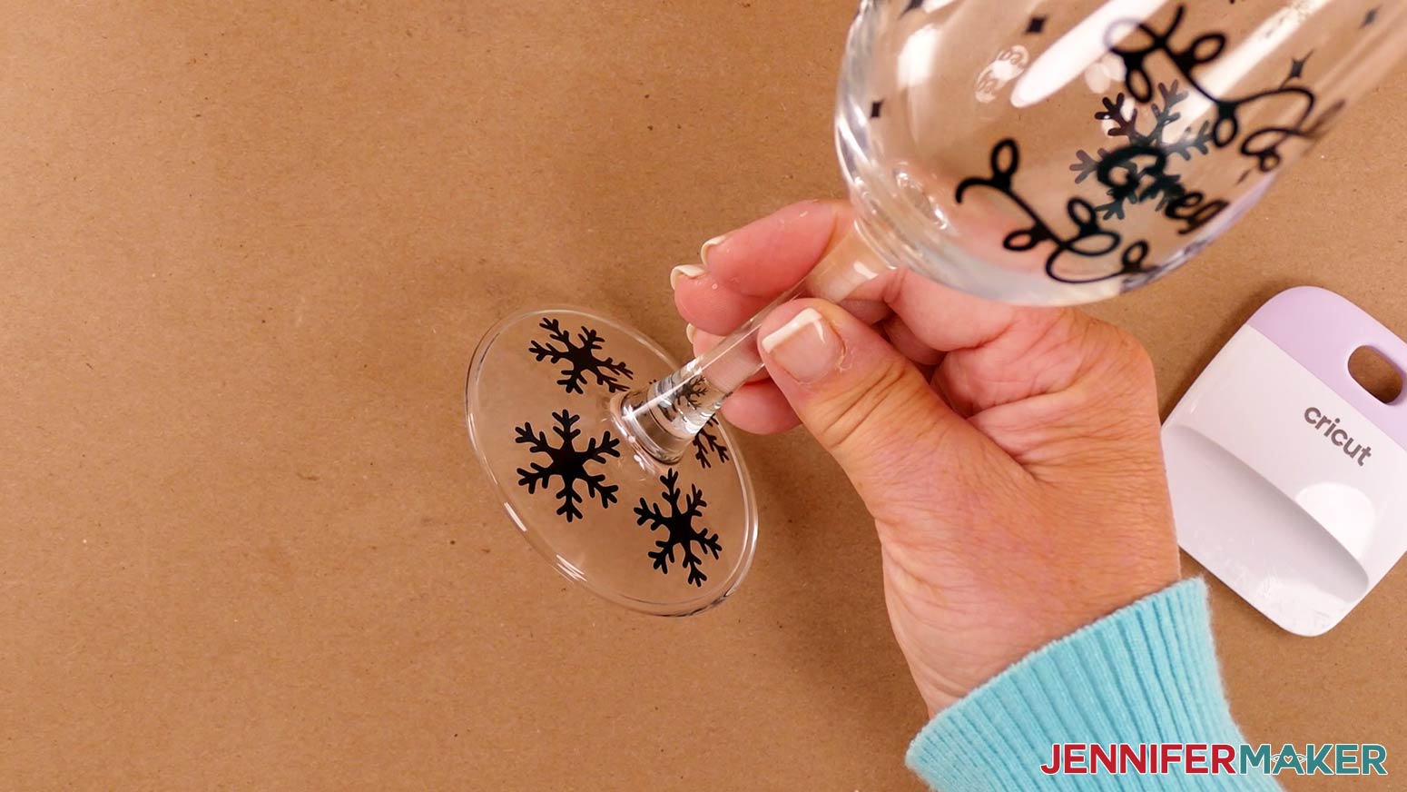 Apply the additional vinyl snowflakes around the base of your wine glass using transfer tape or your fingers before etching