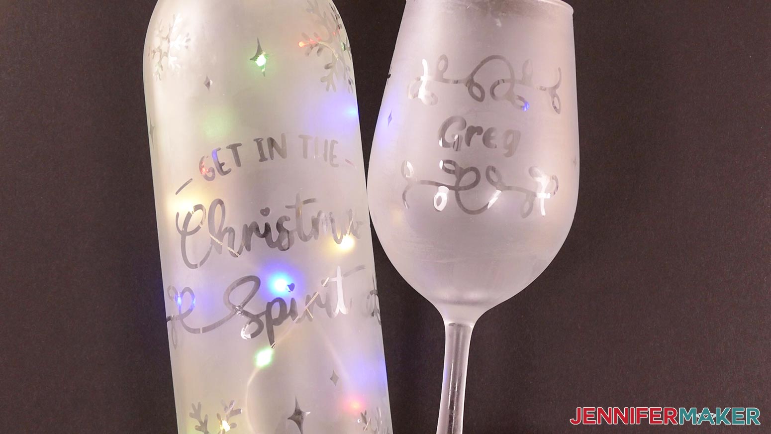 A finished clear wine bottle and glass with the Christmas designs reverse etched onto them for the etched wine glasses and bottles project