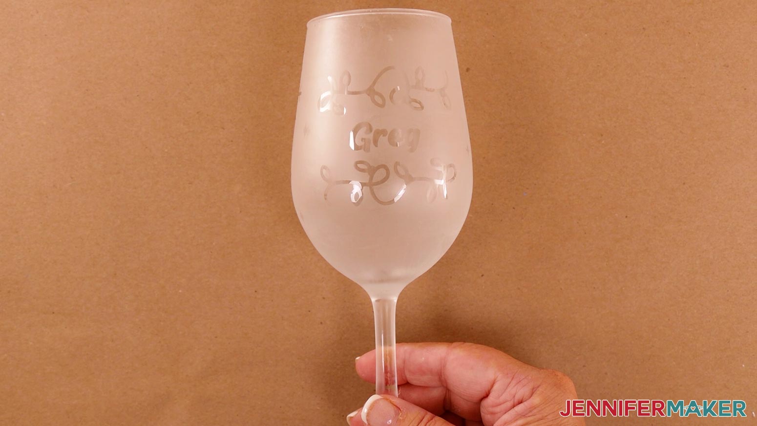 A finished wine glass with the Christmas design reverse etched onto it for the etched wine glasses and bottles project