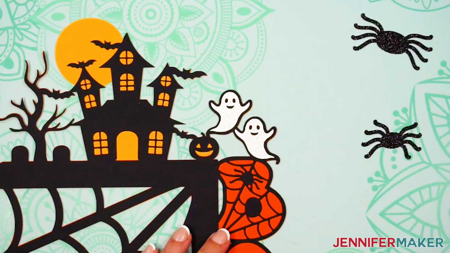The two white glitter ghosts are adhered to the door corner main pieces.