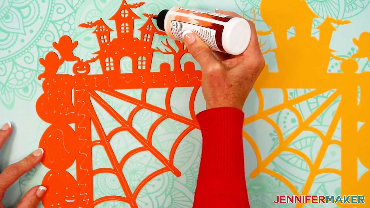 Apply small dots of craft glue to the back of the orange layer of cardstock.