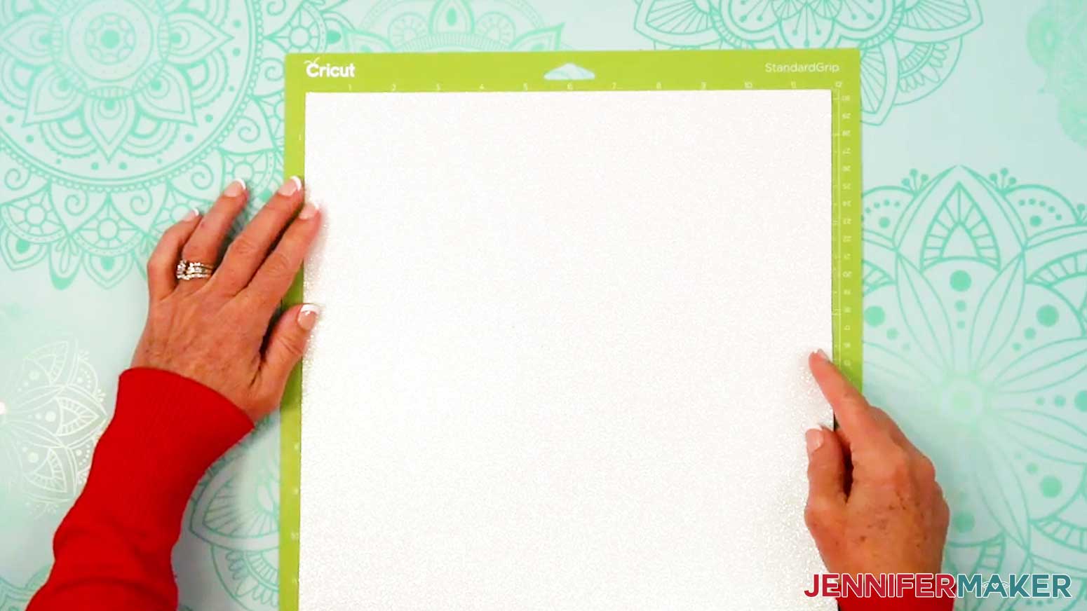 Place the white glitter cardstock on the green machine mat.
