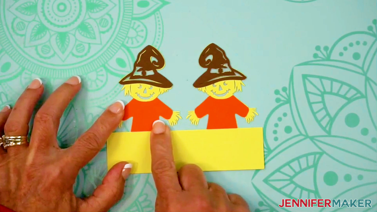 Glue the shirt pieces of the Fall Tea Light Holder Scarecrow into place.