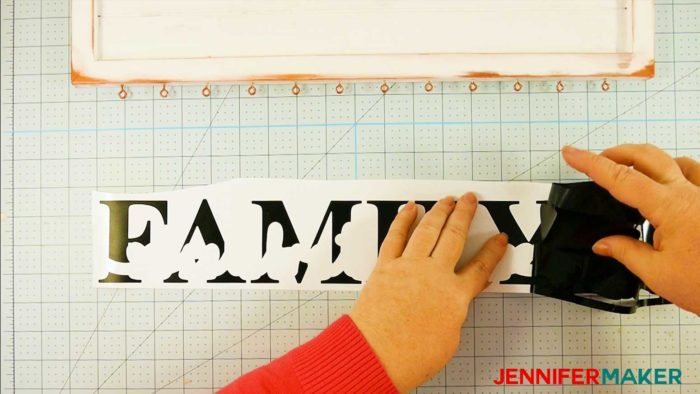 Weeding a black "family" vinyl decal for a family celebration and birthday board