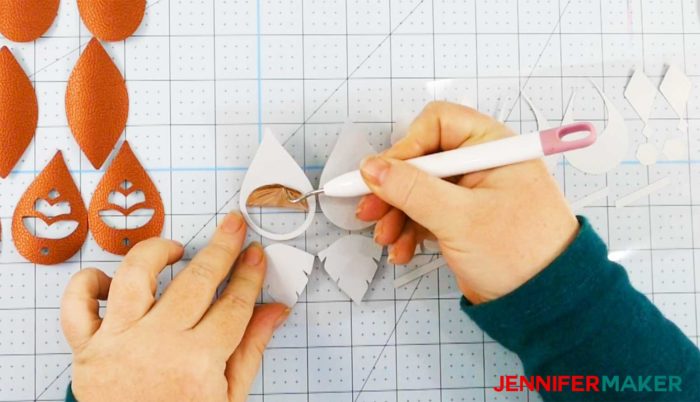 Weeding Cricut foil iron-on vinyl to put onto faux leather earrings