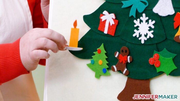 Putting a felt ornament candle onto the Felt Christmas Tree advent calendar