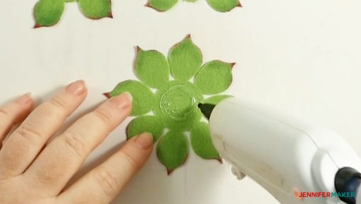 Apply hot glue in a ring in the center of your largest set of leaves