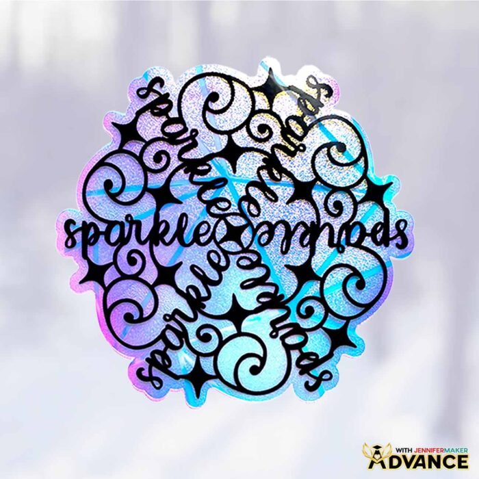 A window from inside the studio at Maker Farm look out onto a snowy landscape -- the windows are decorated with a snowflake-shaped window cling with a custom stylized word art saying "Sparkle" from the Festive Snowflake Designs ADVANCE tutorial